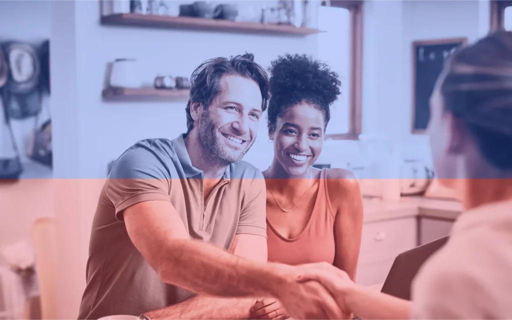 A couple discuss business with a businessperson