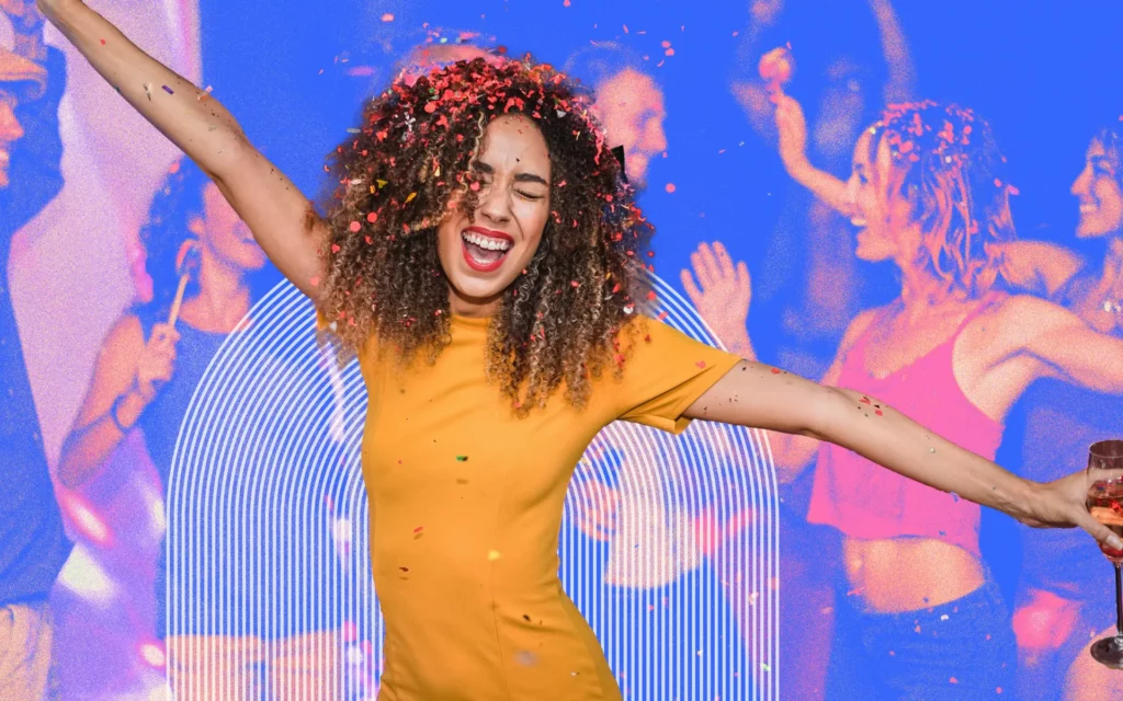 A young woman in a yellow dress celebrates with confetti