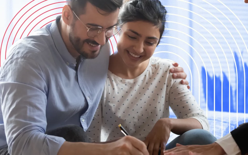 A young couple sign documents in an office setting