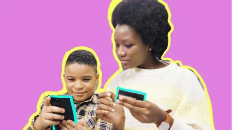 An adult and child looking at their smartphones
