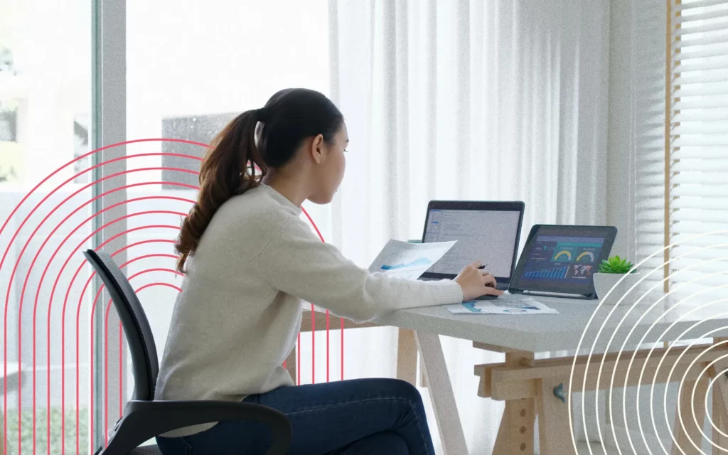 A woman sitting in front of a laptop at a table