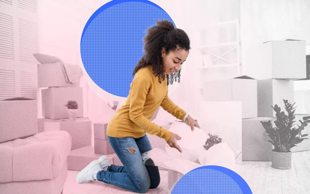 A young lady unpacks a box in her new home